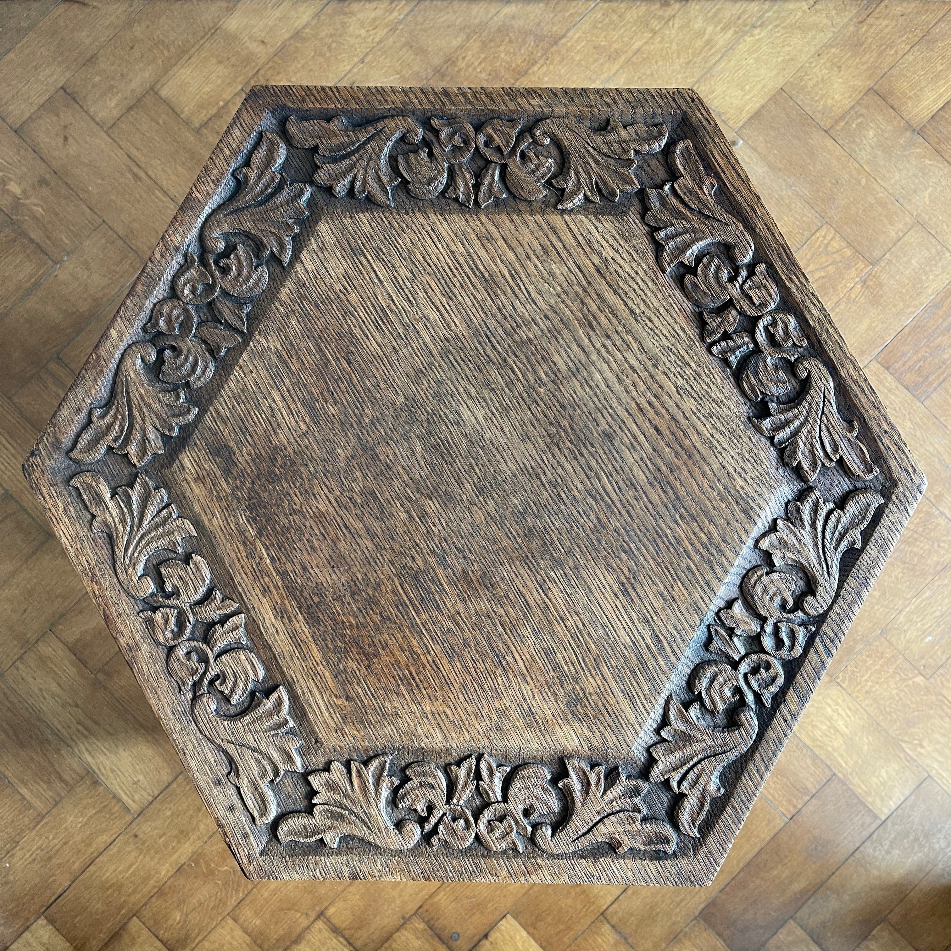 A good looking Carved Oak Side Table. The hexagonal top sees a beautiful hand-carved decorative leaf border with further carving to each of the six side panels. 