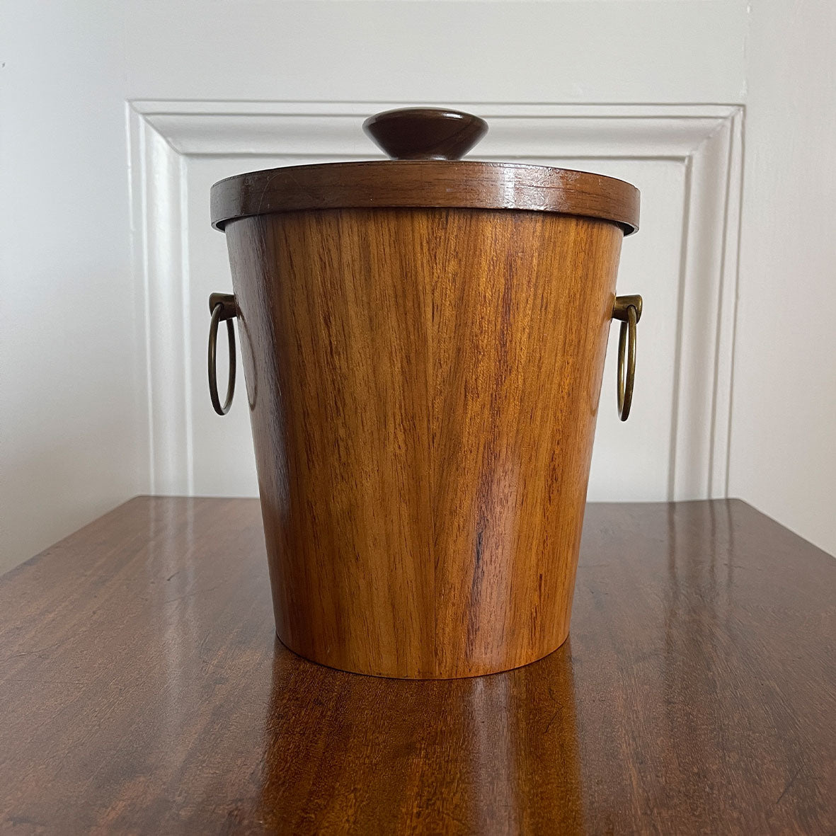 A very cool Vintage Scandinavian Teak Ice Bucket by KMC. Tapered to the base with two brass ring handles to the sides and a teak knob on the lid. Inside is aluminium lined to keep the ice nice and cold. Marked on the bottom with the horse logo - SHOP NOW - www.intovintage.co.uk