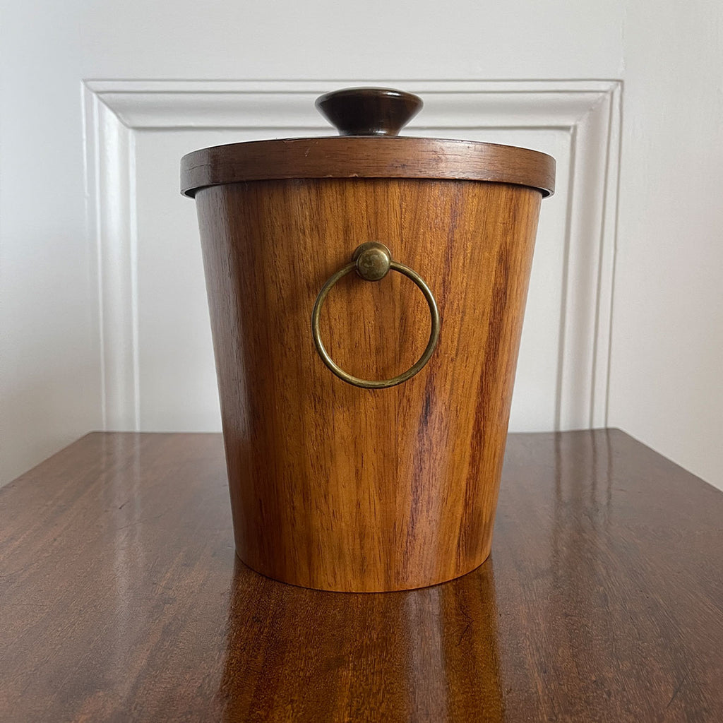 A very cool Vintage Scandinavian Teak Ice Bucket by KMC. Tapered to the base with two brass ring handles to the sides and a teak knob on the lid. Inside is aluminium lined to keep the ice nice and cold. Marked on the bottom with the horse logo - SHOP NOW - www.intovintage.co.uk