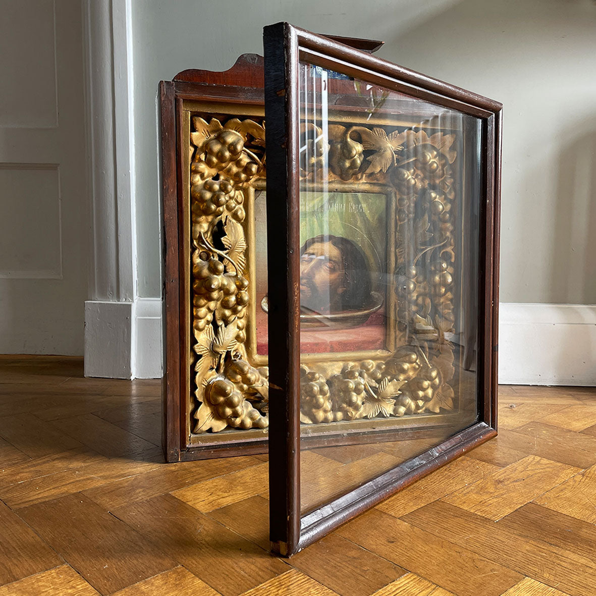 An impressive Russian Church Art Piece of John the Baptist from the Victorian period. The well executed painting is framed in a plaster gilt frame of vine leaves and grapes, this is in-turn inside a stained pine cabinet fronted in its original glass - SHOP NOW - www.intovintage.co.uk