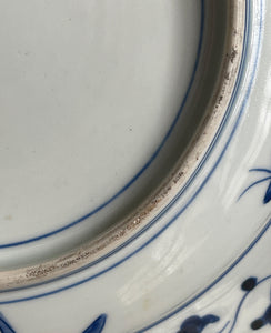 A large Oriental Imari scolloped edged plate with colourful hand painted depictions of Chrysanthemum flowers, fans, birds and cherry blossom. The underside sees a freeze of blue lilies - SHOP NOW - www.intovintage.co.uk