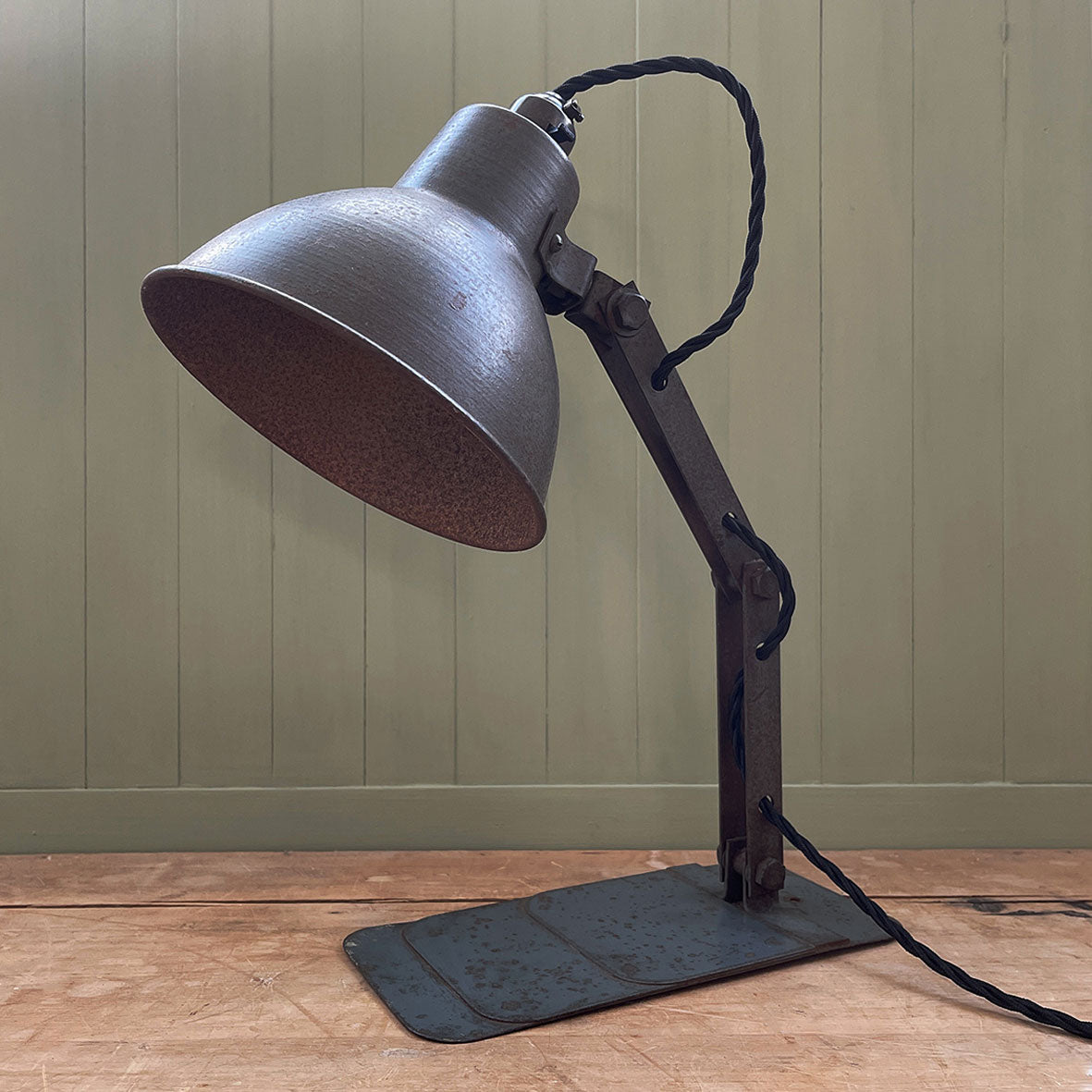 A great looking 1950's Industrial Lamp. Finished in a battleship grey with fantastic patina to its painted surfaces. it has a stepped base with fixing hole so that it can be mounted on a wall or just on a desk  - SHOP NOW - www.intovintage.co.uk