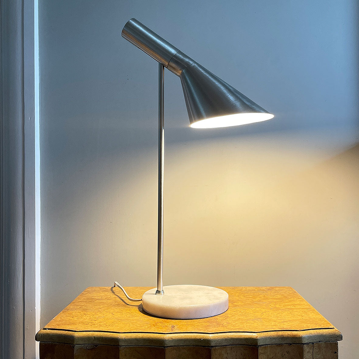 A stylish Carlo Task Lamp with contrasting brushed aluminium metal work with a grey marble base. The lamp head is adjustable and can be positioned in an up or down position - SHOP NOW - www.intovintage.co.uk