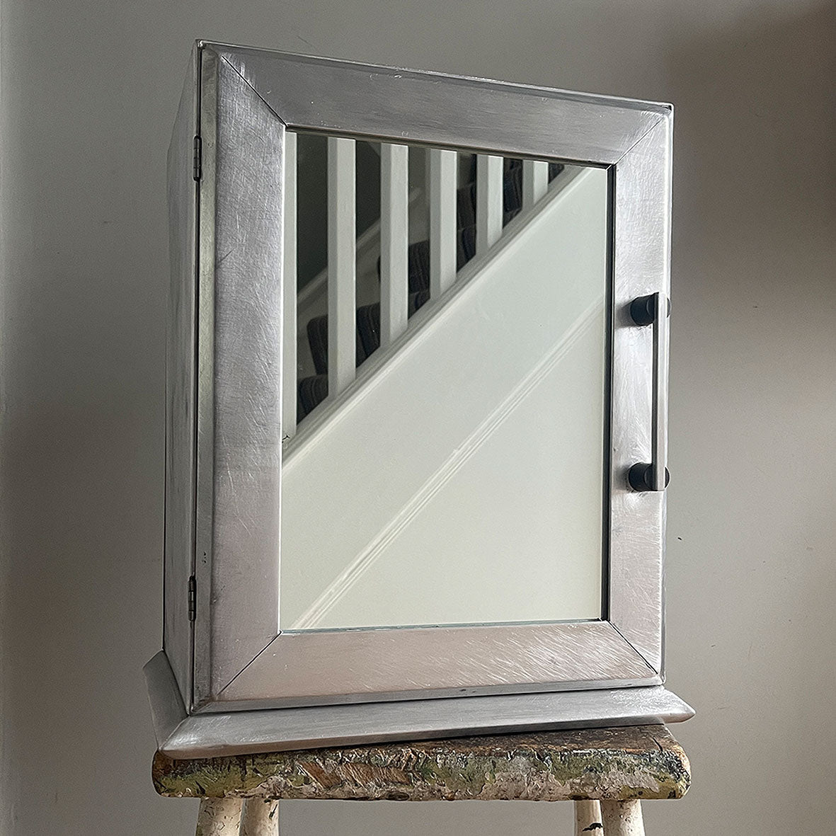 A Vintage Medical Cabinet from the 1930s with a Deco style chrome & bakelite handle to the door. The paint has been removed from the outside to leave a bare aluminium finish. The inside and shelf has its original cream finish - SHOP NOW - www.intovintage.co.uk