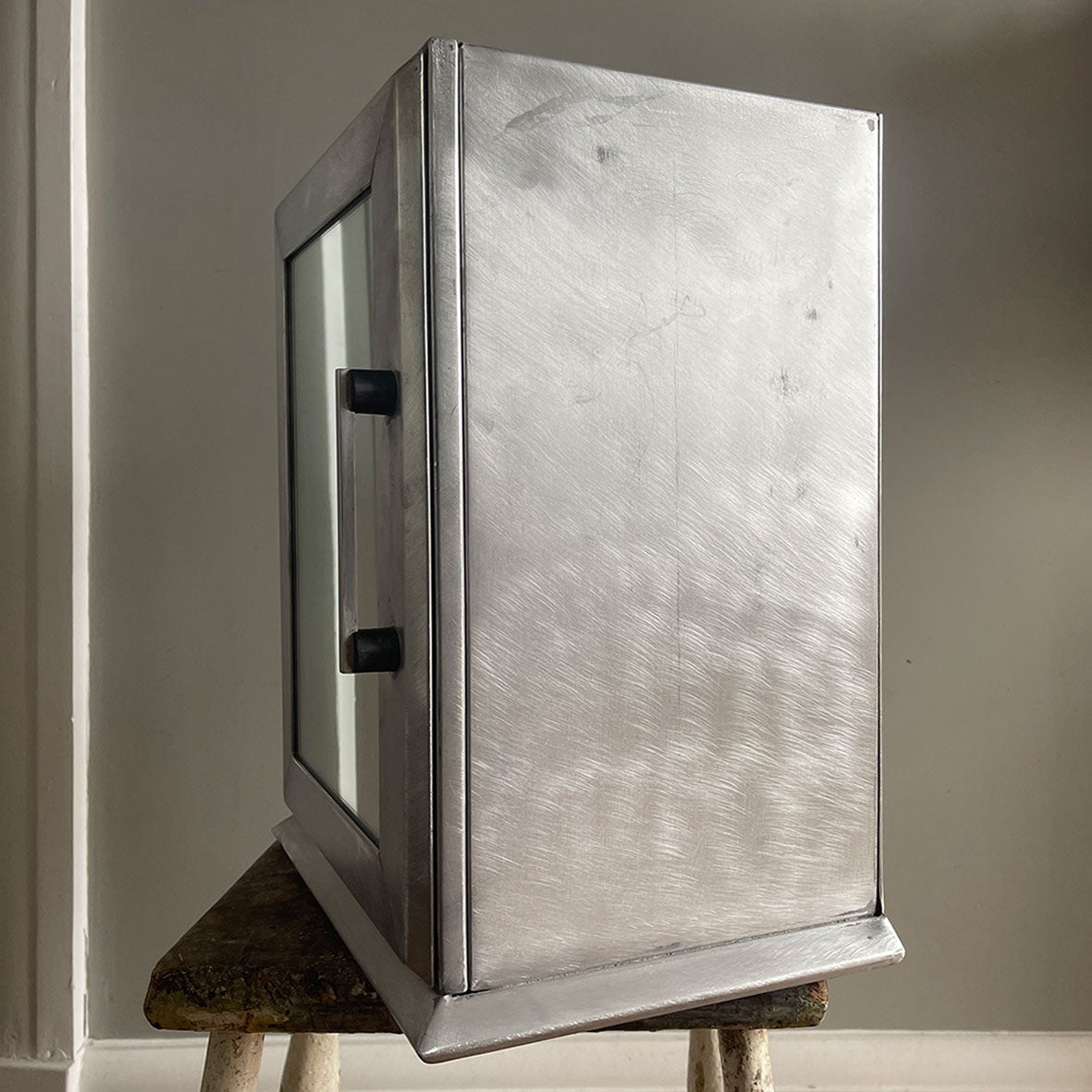 A Vintage Medical Cabinet from the 1930s with a Deco style chrome & bakelite handle to the door. The paint has been removed from the outside to leave a bare aluminium finish. The inside and shelf has its original cream finish - SHOP NOW - www.intovintage.co.uk