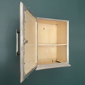 A Vintage Medical Cabinet from the 1930s with a Deco style chrome & bakelite handle to the door. The paint has been removed from the outside to leave a bare aluminium finish. The inside and shelf has its original cream finish - SHOP NOW - www.intovintage.co.uk