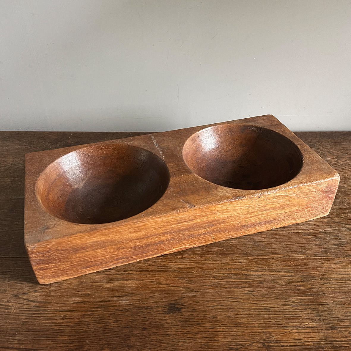 A 1930s Antique Money. Made of solid Mahogany, it has 2 deep bored bowls where money would have been kept. These trays were made to be used by shop keeps and market traders in the late 19th and early 20th century - SHOP NOW - www.intovintage.co.uk