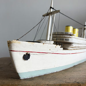 A delightful vintage scratch built Ship with a little secret. Wind her up and she plays a little ditty on an internal musical box. Based on the SS Empress of Britain she's a pretty little ship that would look great in a bathroom! SHOP NOW - www.intovintage.co.uk