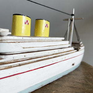 A delightful vintage scratch built Ship with a little secret. Wind her up and she plays a little ditty on an internal musical box. Based on the SS Empress of Britain she's a pretty little ship that would look great in a bathroom! SHOP NOW - www.intovintage.co.uk