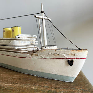 A delightful vintage scratch built Ship with a little secret. Wind her up and she plays a little ditty on an internal musical box. Based on the SS Empress of Britain she's a pretty little ship that would look great in a bathroom! SHOP NOW - www.intovintage.co.uk