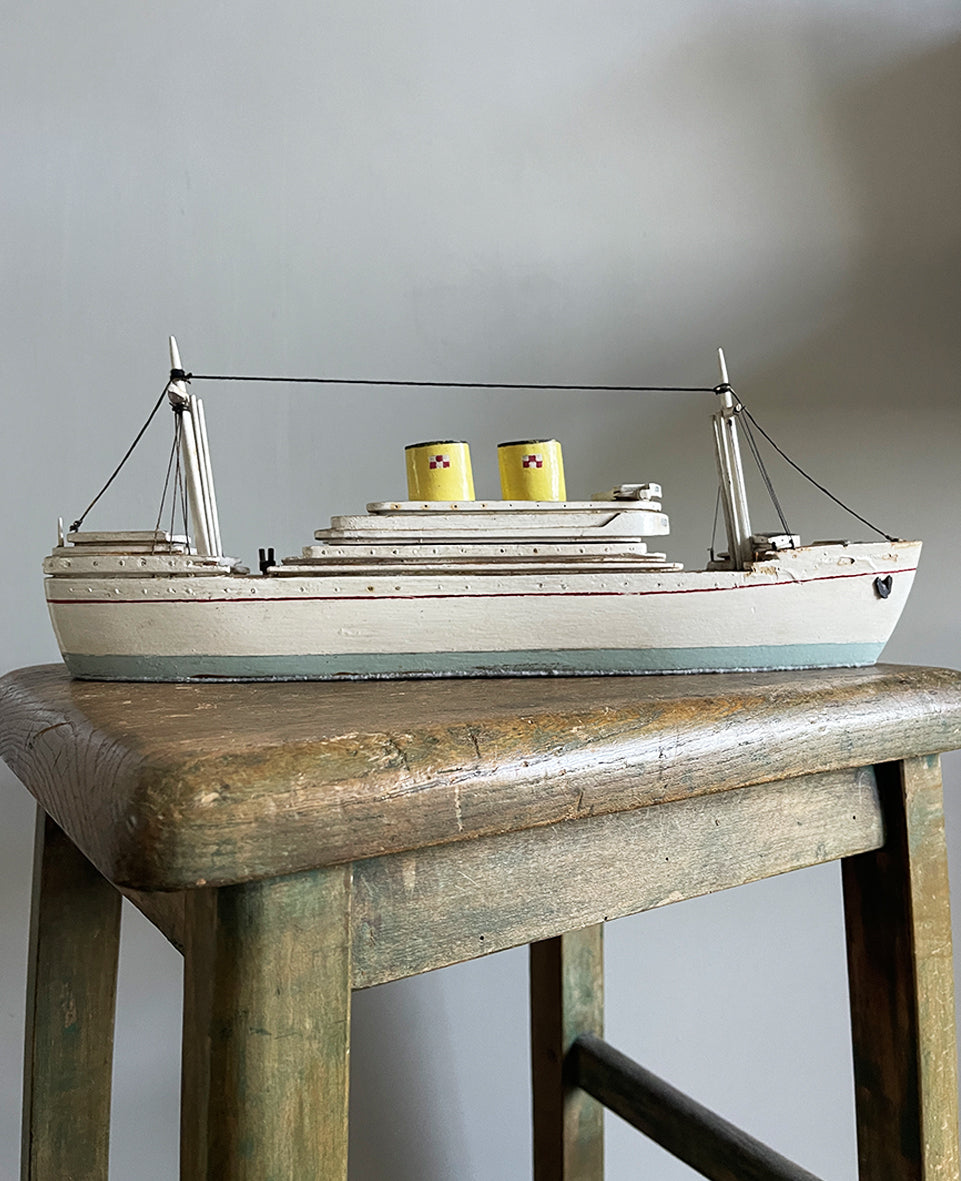 A delightful vintage scratch built Ship with a little secret. Wind her up and she plays a little ditty on an internal musical box. Based on the SS Empress of Britain she's a pretty little ship that would look great in a bathroom! SHOP NOW - www.intovintage.co.uk