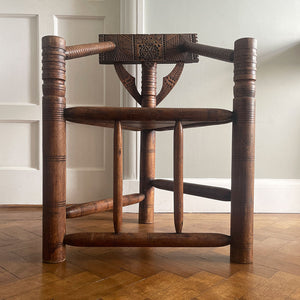 A late 19th century Oak Turners Chair in the Warwick style. With a chip carved back, turned bobbin arms, triangular seat and standing on three turned legs united by stretchers - SHOP NOW - www.intovintage.co.uk