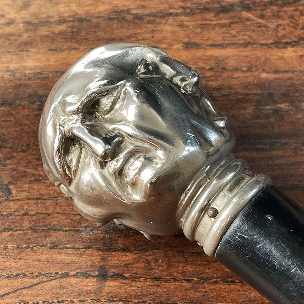 A Victorian Page Turner from around the 1870 period. A silvered head showing four characterful faces sits atop an ebonised wooden blade. The faces represent mirth, sadness, shock and anger - SHOP NOW - www.intovintage.co.uk