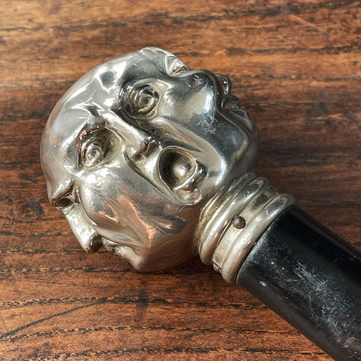 A Victorian Page Turner from around the 1870 period. A silvered head showing four characterful faces sits atop an ebonised wooden blade. The faces represent mirth, sadness, shock and anger - SHOP NOW - www.intovintage.co.uk