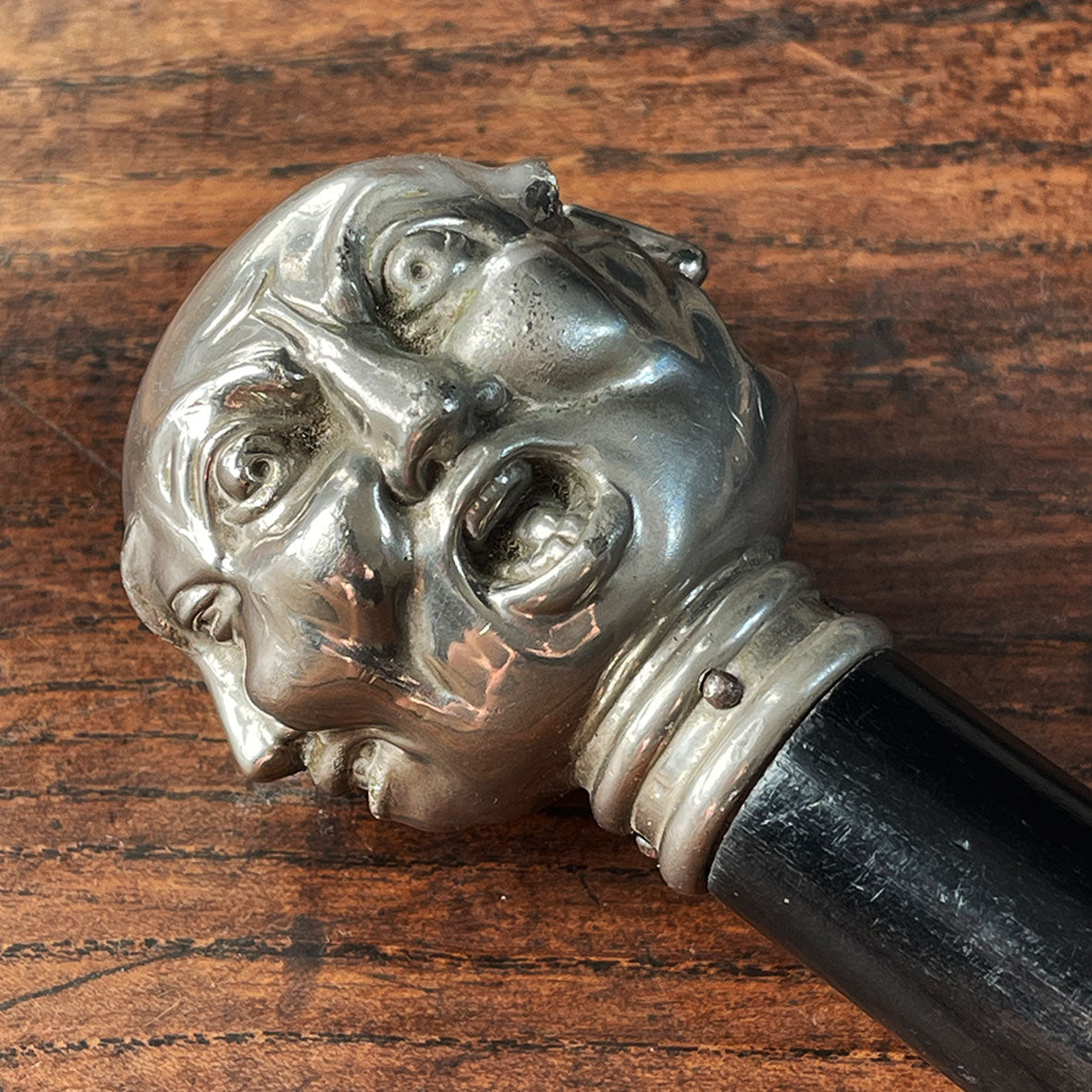 A Victorian Page Turner from around the 1870 period. A silvered head showing four characterful faces sits atop an ebonised wooden blade. The faces represent mirth, sadness, shock and anger - SHOP NOW - www.intovintage.co.uk