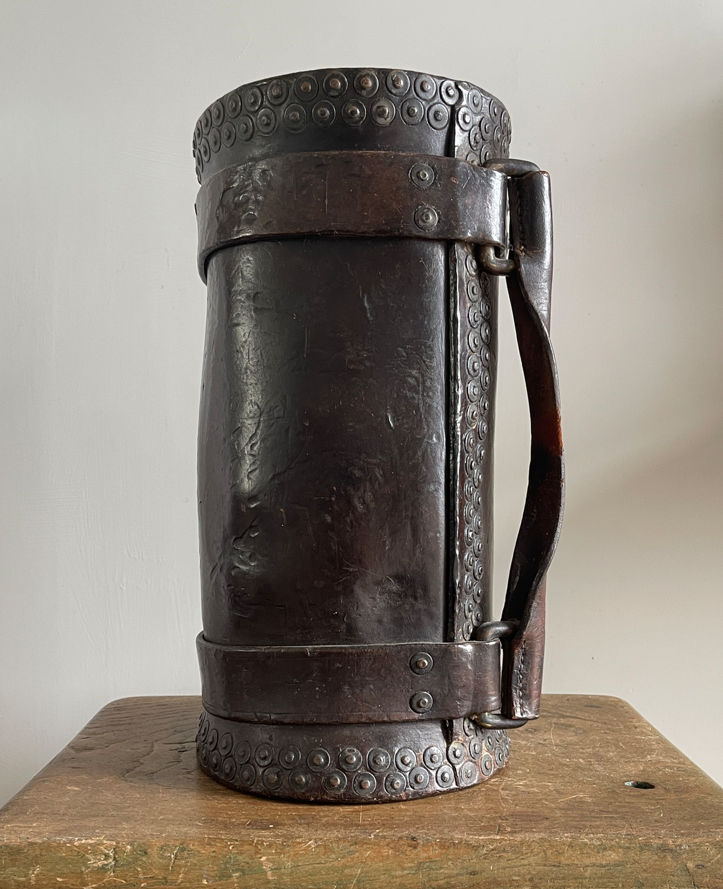 A 19th Century Royal Navy Clarkson's case. These slim leather buckets were used to carry charges on board Royal Naval vessels and would have been loaded with charges in the magazine quarters of a ship and then hoisted up to the onboard gun positions for use. This rarer example has the side handle and fantastic copper studding to the rim base and side - SHOP NOW - www.intovintage.co.uk