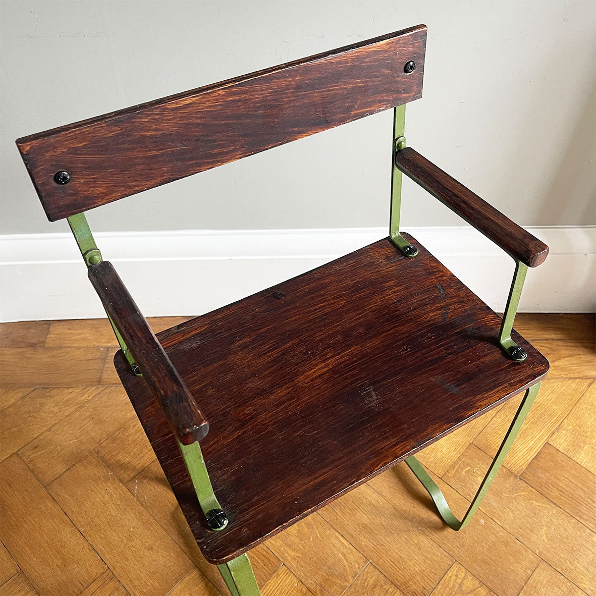 A 1950's scratch built chair sized for a small child. Of steel construction with ply seat, arms and back rest. Still in its original green paint - SHOP NOW - www.intovintage.co.uk