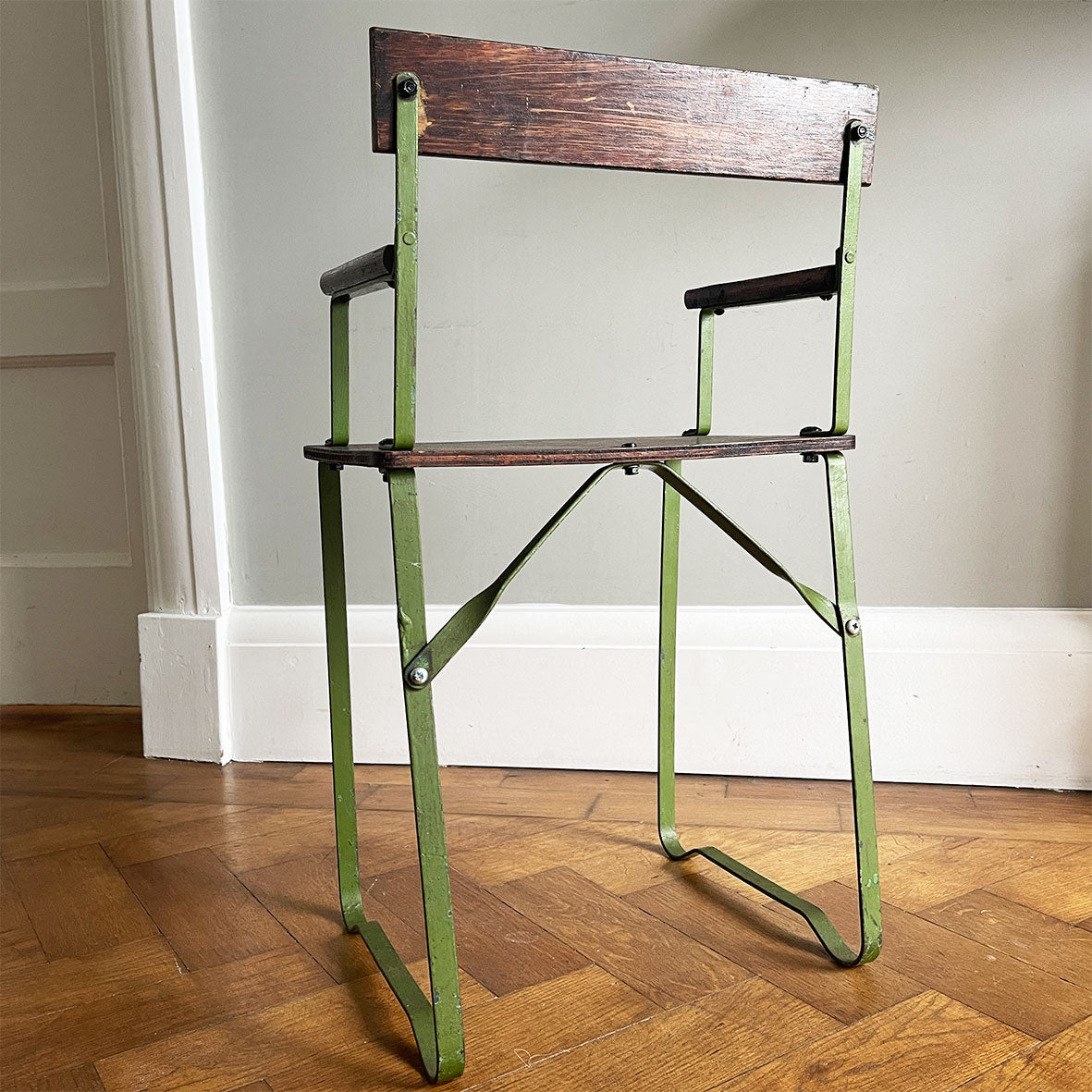 A 1950's scratch built chair sized for a small child. Of steel construction with ply seat, arms and back rest. Still in its original green paint - SHOP NOW - www.intovintage.co.uk