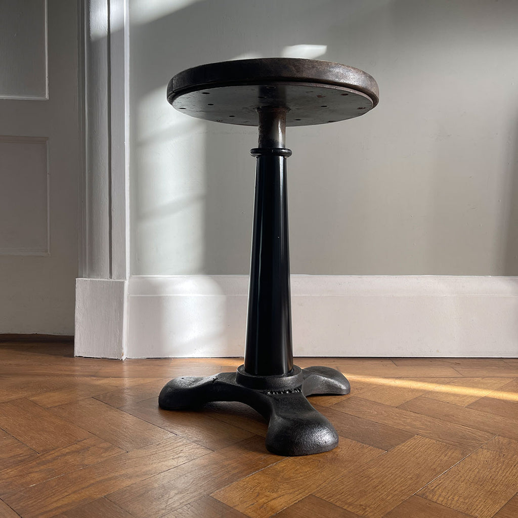 An Antique Singer Work Stool. It has a cast iron tripod base with the SINGER brand mark, a black painted steel stem and original turned wooden button seat. The wood shows fantastic age related patina. A great looking stool that would compliment any setting - SHOP NOW - www.intovintage.co.uk