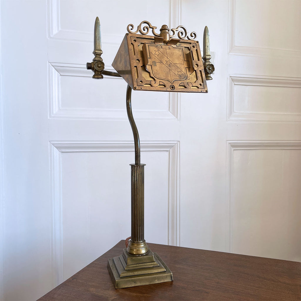 An interesting Gothic Brass Table Lamp with coat of arms to the front. The lamp sits a-top a brass fluted column base with swan neck. Wired for electricity with antique fabric covered cable, new plug and pat tested. - SHOP NOW - www.intovintage.co.uk