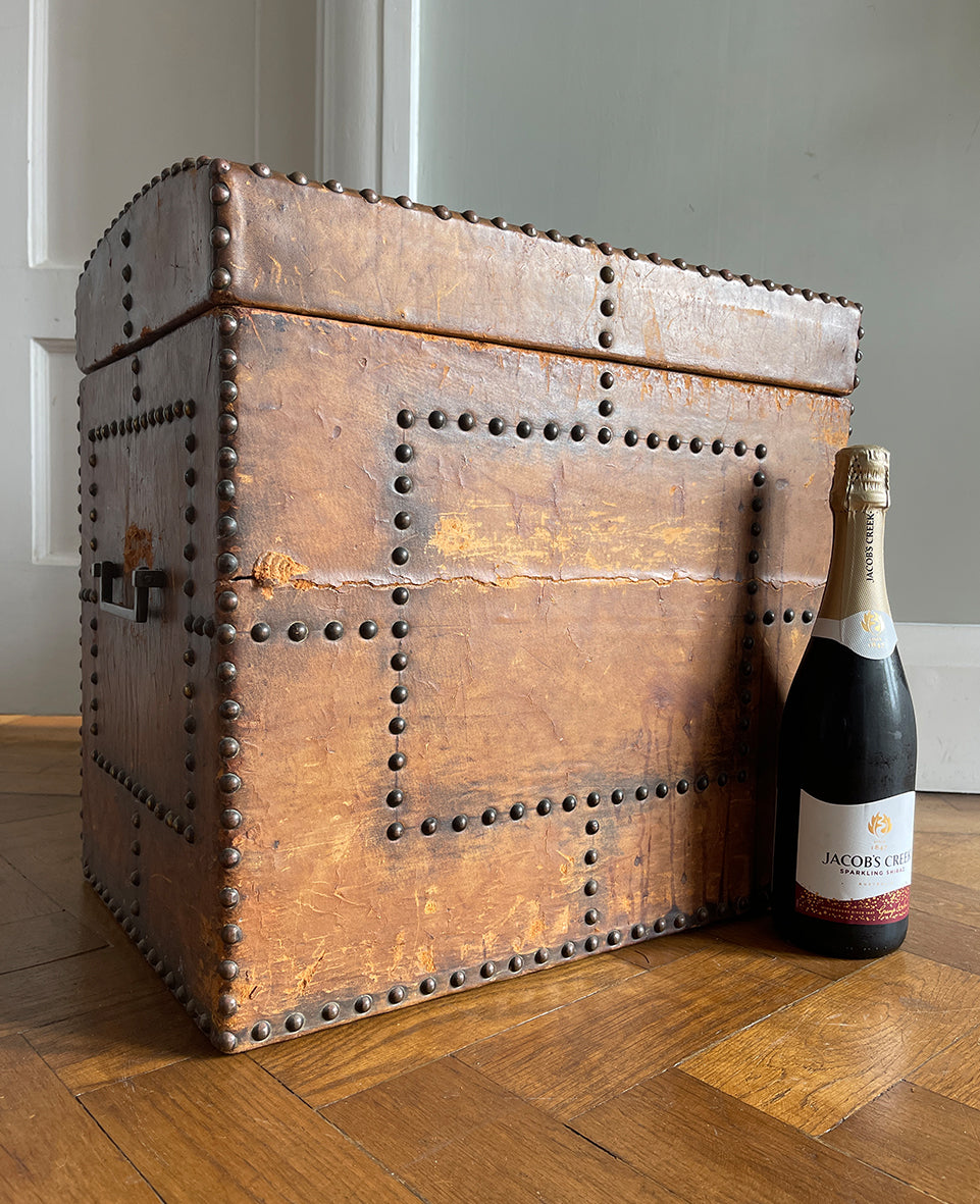 A stunning leather clad and brass studded Wine Chest with a great aged look, wear and colour. It has a hinged and barrel top with sturdy brass handle on each side. Inside sees an inner metal bin with handy handles making it easy to remove. Will hold 12 bottles of wine - SHOP NOW - www.intovintage.co.uk