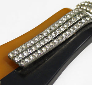 A magnificent art deco dress clip topped with diamantes. The duo colour base is topped with diamantes set in silvertone metal. It can be clipped to a dress or coat to add instant deco glamour - SHOP NOW - www.intovintage.co.uk
