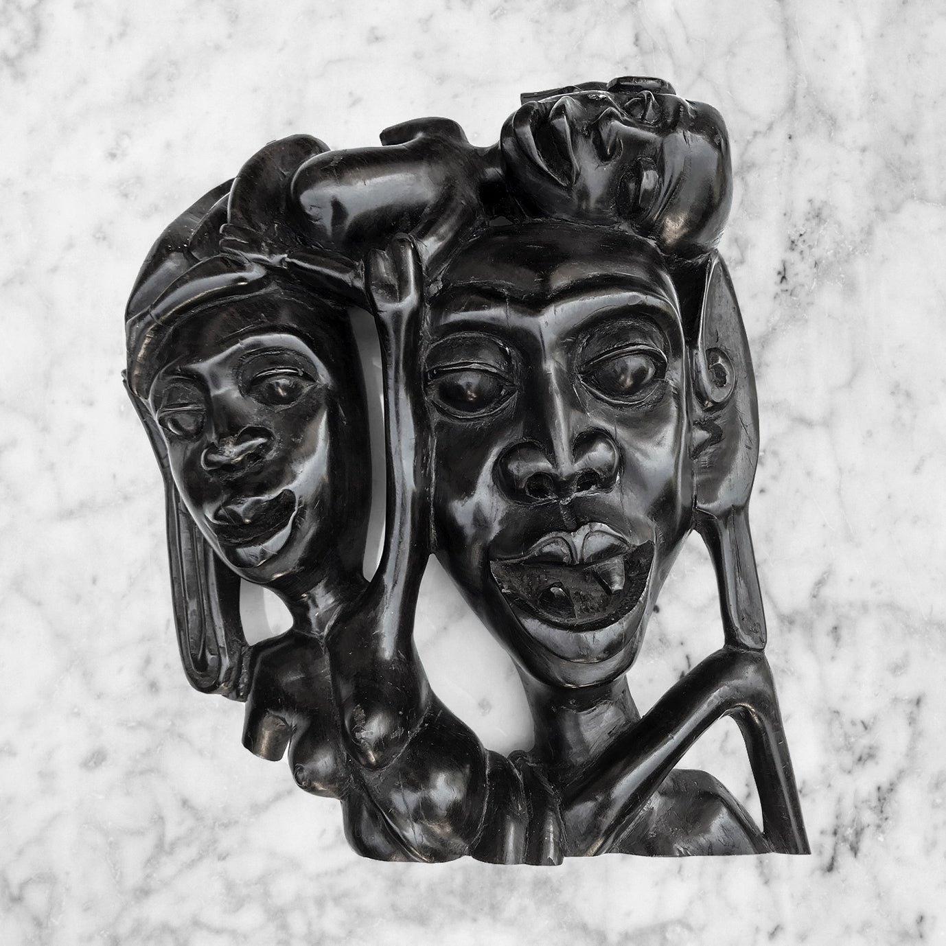 A wonderful Tribal Carving in ebony wood. It has three characterful heads, a man, woman and child. The man has gruesome fangs and long loopy ear lobes! Incredibly detailed and beautifully finished. A solid piece And very heavy - SHOP NOW - www.intovintage.co.uk