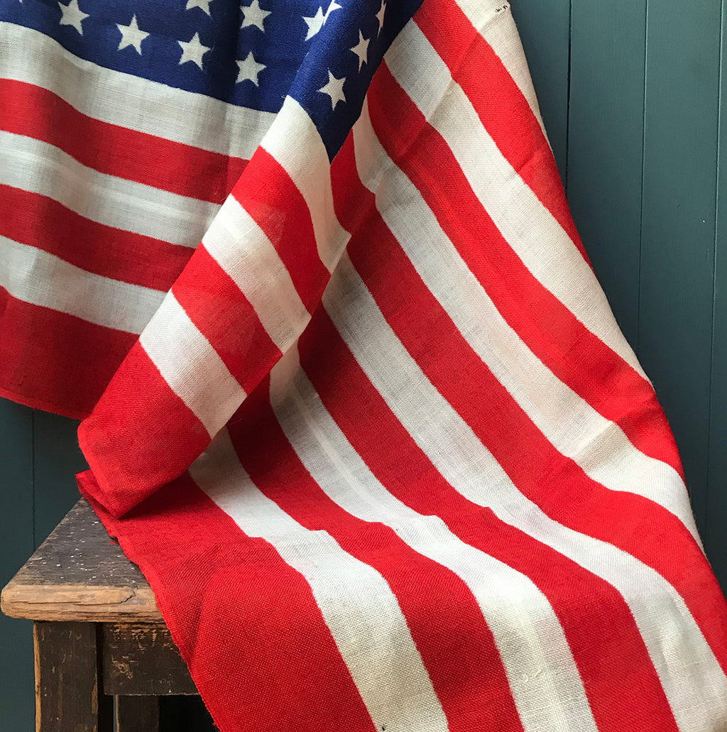 Vintage American Flag that has never been used so super fresh! Great strong red & blue colours. Marked '1 YD AMERICA' on the seem. These flags look great framed and hung on the wall - SHOP NOW - www.intovintage.co.uk