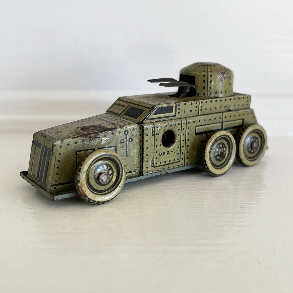 A Cool little Pre-War 1930s Kellerman tin-plate clockwork Panzerspahwagen Armoured Car. It has a clockwork movement, that when wound propels the car forward and shoots bright sparks out of the gun turret. Marked 'D.R.G.M' just under the key hole and 'FOREIGN' above the front wheel - SHOP NOW - www.intovintage.co.uk