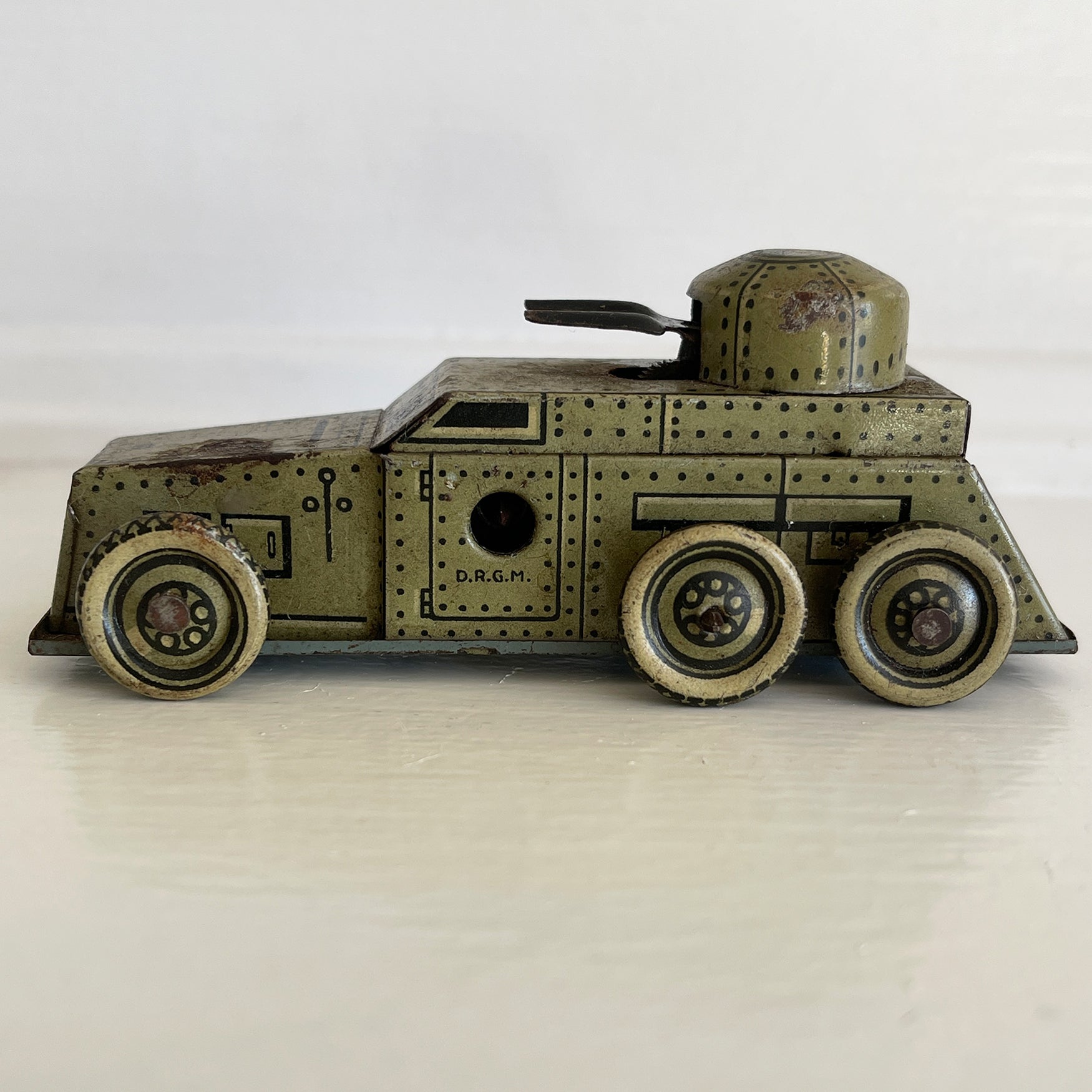 A Cool little Pre-War 1930s Kellerman tin-plate clockwork Panzerspahwagen Armoured Car. It has a clockwork movement, that when wound propels the car forward and shoots bright sparks out of the gun turret. Marked 'D.R.G.M' just under the key hole and 'FOREIGN' above the front wheel - SHOP NOW - www.intovintage.co.uk