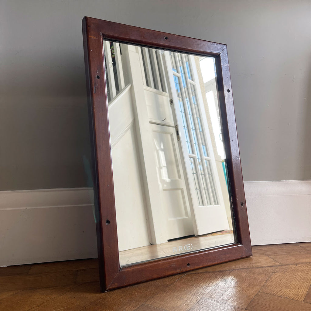 A vintage British Railways East Carriage Mirror etched with the initials 'B.R.(E)' on the mirror plate. The frame is in mahogany with four fixing holes where it would have been mounted in the carriage - SHOP NOW - www.intovintage.co.uk