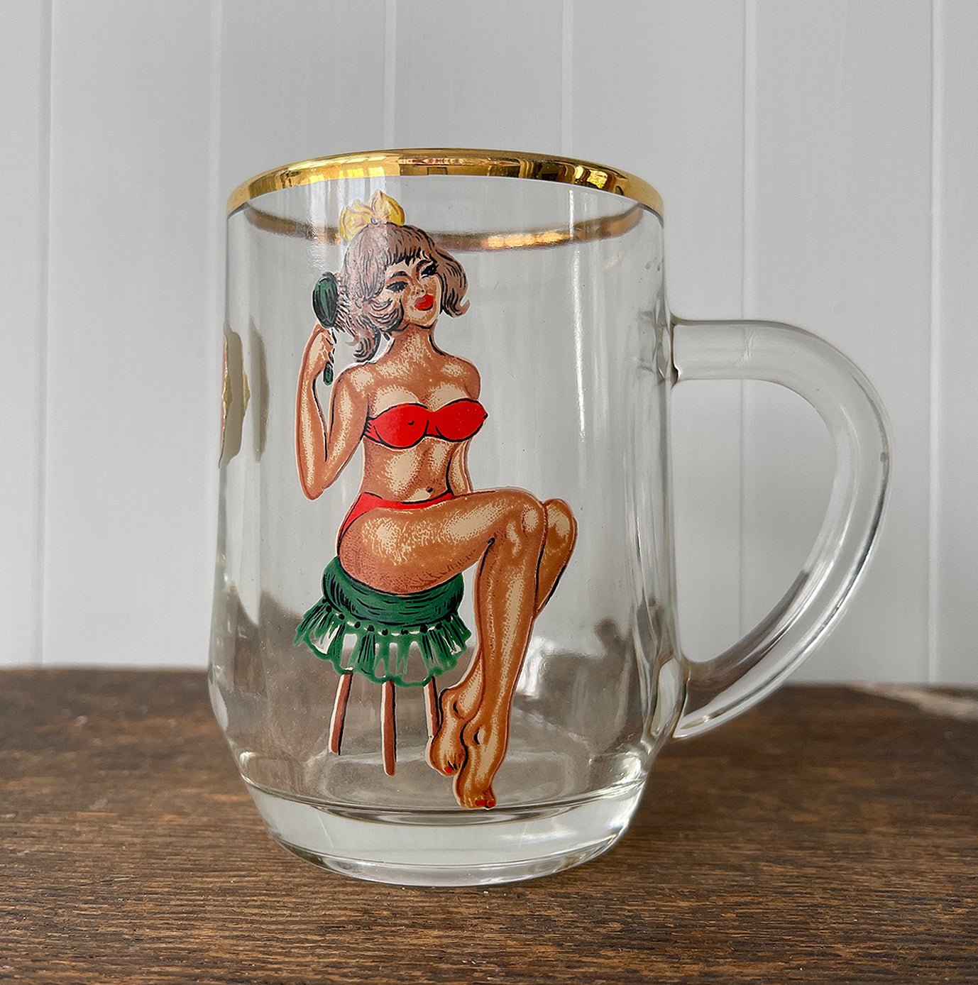 A Super Kitsch Vintage Prince William Ware Tankard with a naughty secret! On the front of a glass the young lady is wearing a red bikini sitting on a stool brushing her hair, turn it round and her bikini disappears and she's sitting there in her birthday suit! - SHOP NOW - www.intovintage.co.uk