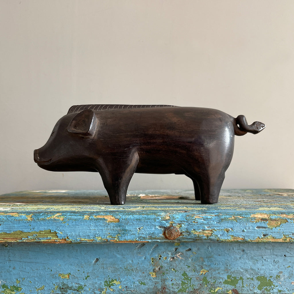 A superb tribal carving of a wild boar. He has a fantastic strong look to him, with a Mohican like mane, super curly tail with snakes head detail carved in. A very fine specimen! SHOP NOW - www.intovintage.co.uk