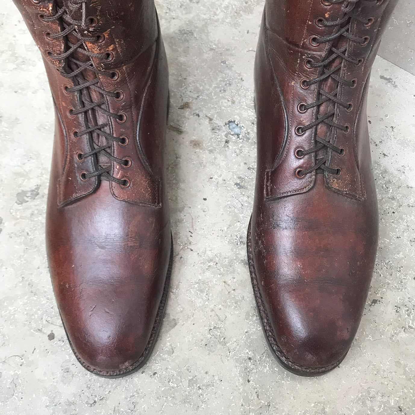 Pair of Antique British Army Officers Cavalry Boots in wonderful condition. Finished in brown leather with laces to the bottom section of the boot and leather soles. Each boot has its original wooden stave with the Faulkner & Son makers mark and topped off with a sturdy brass pull ring - SHOP NOW - www.intovintage.co.uk
