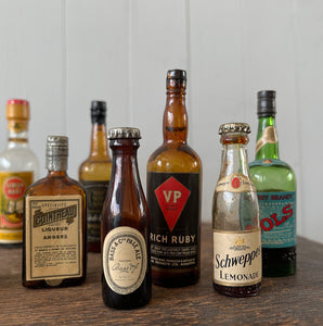 11 mini bottles of vintage Alcohol brands. Not drinkable, but great little display pieces! Brands include Bass, Gilbey's Lemon Heart, Bols, Schweppes and Cointreau - SHOP NOW - www.intovintage.co.uk