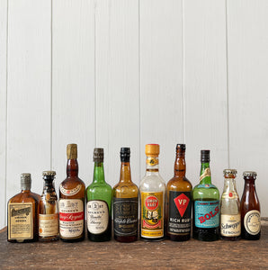 11 mini bottles of vintage Alcohol brands. Not drinkable, but great little display pieces! Brands include Bass, Gilbey's Lemon Heart, Bols, Schweppes and Cointreau - SHOP NOW - www.intovintage.co.uk