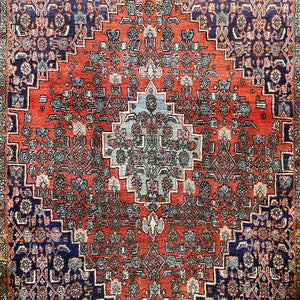 A beautiful, rich dark blue and red handmade Persian Heriz rug in wool. The overall condition is very good. With one pale blue central medallion decoration on a red diamond background framed by deep blue. A good practical size - SIZE: (L) 150cm   (W) 115cm - SHOP NOW www.intovintage.co.uk