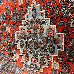 A beautiful, rich dark blue and red handmade Persian Heriz rug in wool. The overall condition is very good. With one pale blue central medallion decoration on a red diamond background framed by deep blue. A good practical size - SIZE: (L) 150cm   (W) 115cm - SHOP NOW www.intovintage.co.uk