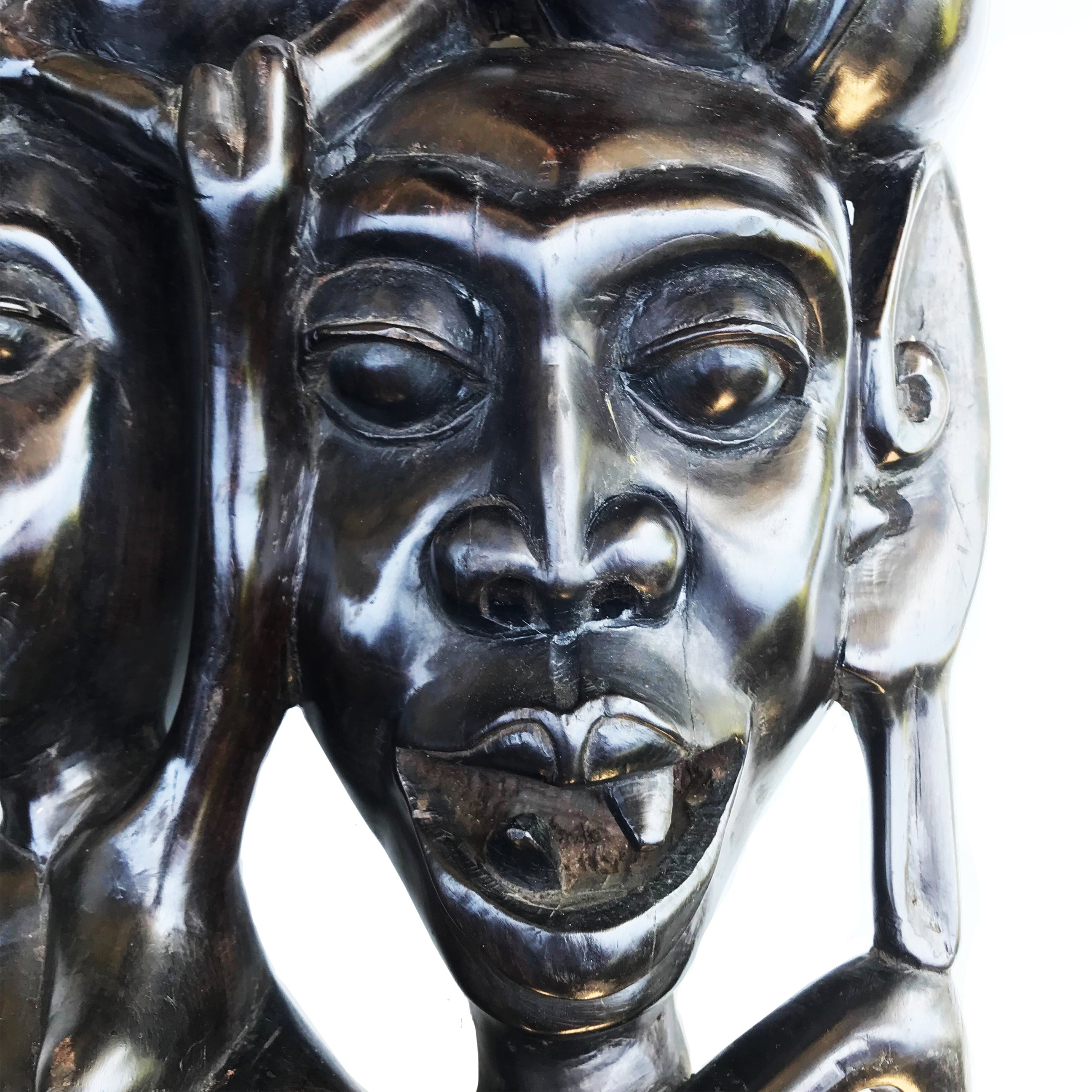 A wonderful Tribal Carving in ebony wood. It has three characterful heads, a man, woman and child. The man has gruesome fangs and long loopy ear lobes! Incredibly detailed and beautifully finished. A solid piece And very heavy - SHOP NOW - www.intovintage.co.uk