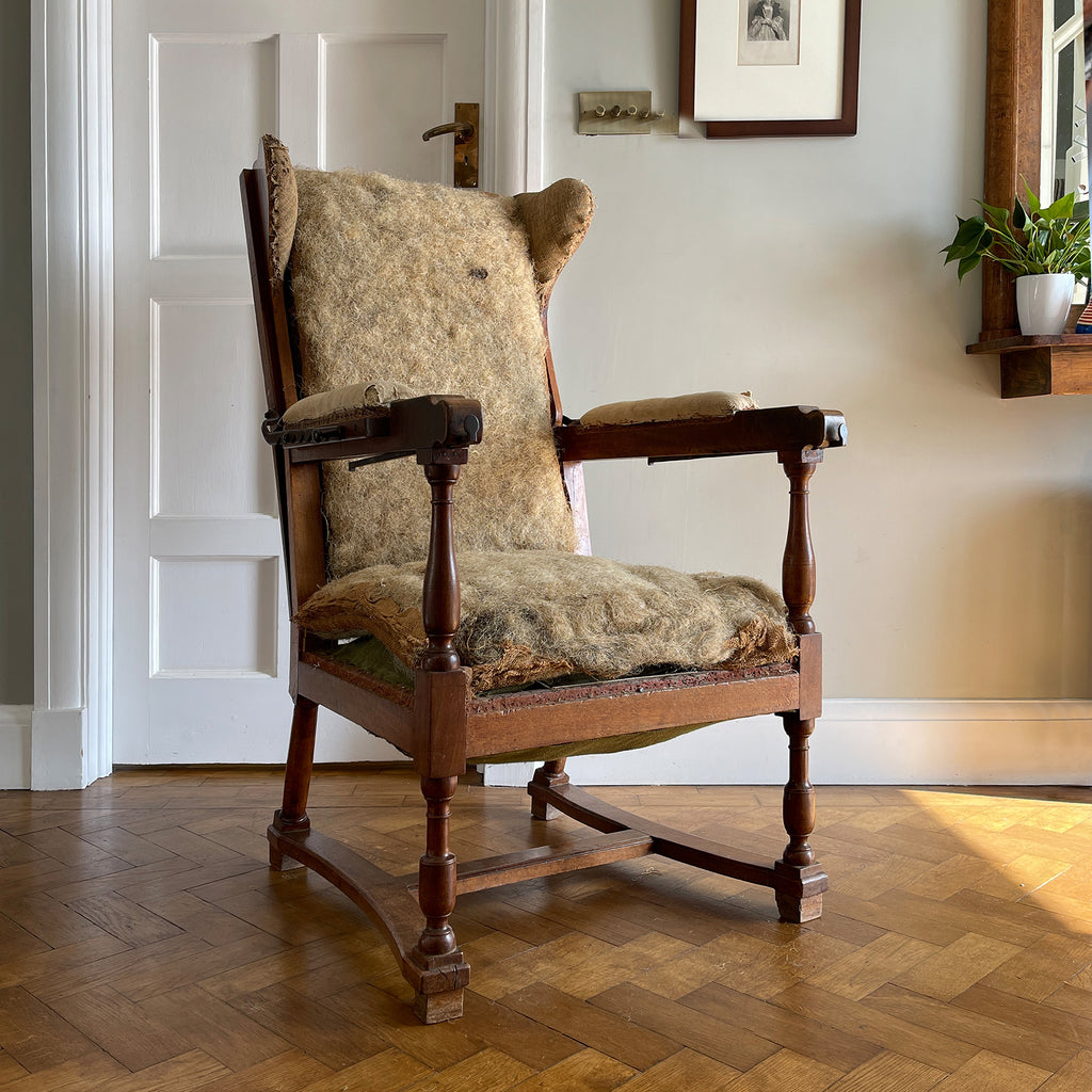 A French Walnut Reclining Armchair Circa 1860. The wing back has seven adjustable positions activated via a simple iron ratchet system. The arms have extendable iron rods. Raised on turned legs with an 'H' shaped stretcher. With original horsehair & ready to be upholstered - SHOP NOW - www.intovintage.co.uk