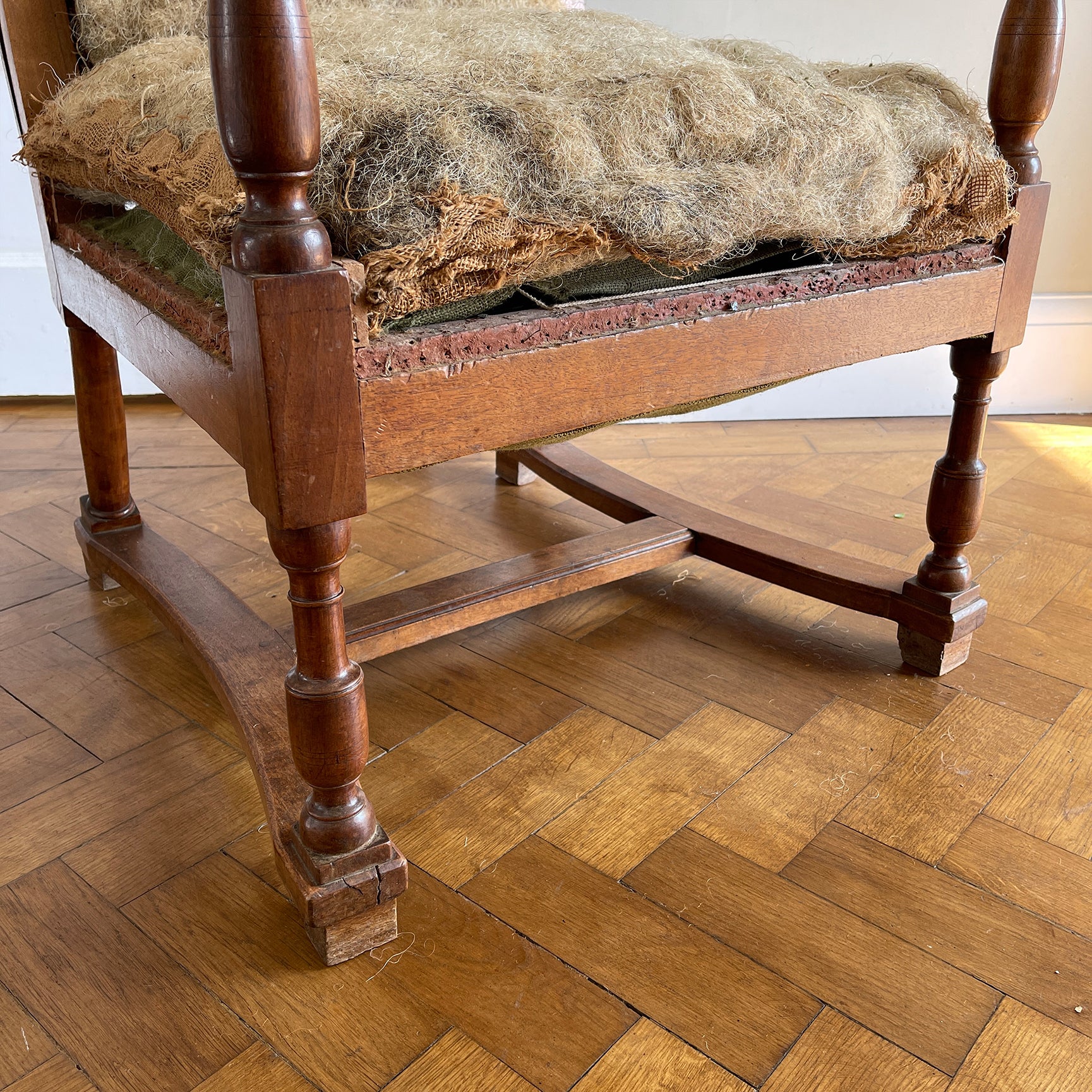A French Walnut Reclining Armchair Circa 1860. The wing back has seven adjustable positions activated via a simple iron ratchet system. The arms have extendable iron rods. Raised on turned legs with an 'H' shaped stretcher. With original horsehair & ready to be upholstered - SHOP NOW - www.intovintage.co.uk