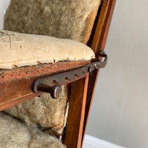 A French Walnut Reclining Armchair Circa 1860. The wing back has seven adjustable positions activated via a simple iron ratchet system. The arms have extendable iron rods. Raised on turned legs with an 'H' shaped stretcher. With original horsehair & ready to be upholstered - SHOP NOW - www.intovintage.co.uk