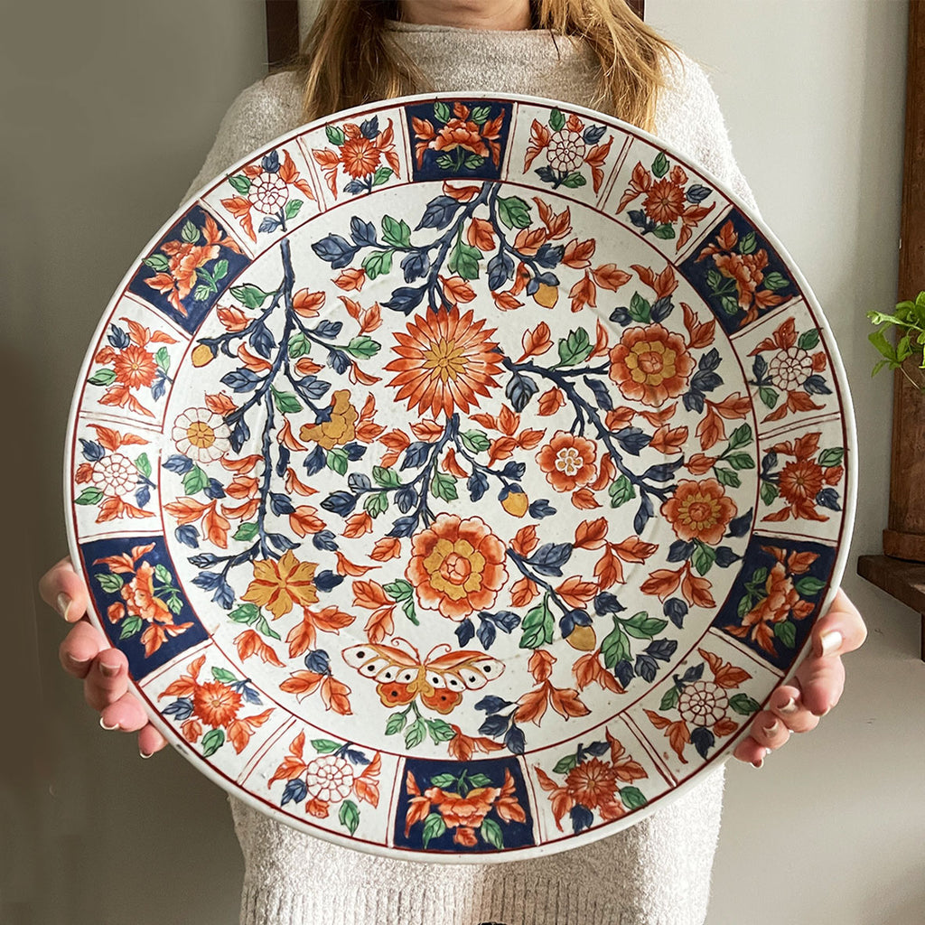 A large Oriental Charger Plate with colourful hand painted depictions of Chrysanthemum flowers and Butterfly. Decoration of flowers and signed to the underside. DIMENSIONS 47cm (Circumference) - SHOP NOW - www.intovintage.co.uk