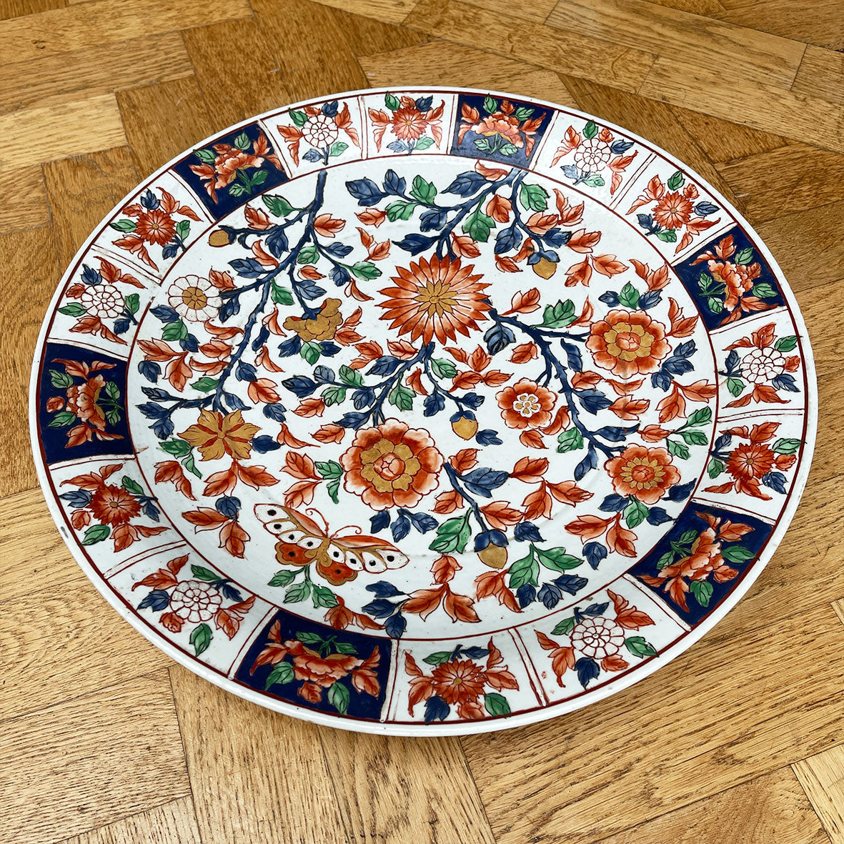 A large Oriental Charger Plate with colourful hand painted depictions of Chrysanthemum flowers and Butterfly. Decoration of flowers and signed to the underside. DIMENSIONS 47cm (Circumference) - SHOP NOW - www.intovintage.co.uk