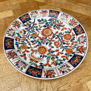 A large Oriental Charger Plate with colourful hand painted depictions of Chrysanthemum flowers and Butterfly. Decoration of flowers and signed to the underside. DIMENSIONS 47cm (Circumference) - SHOP NOW - www.intovintage.co.uk