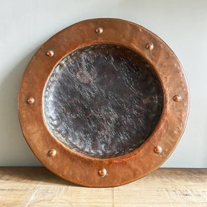 A large hand beaten Arts & Crafts Copper Charger in the Cornish Newlyn style. Beautiful colour and texture. Looks amazing as a table piece - SHOP NOW - www.intovintage.co.uk