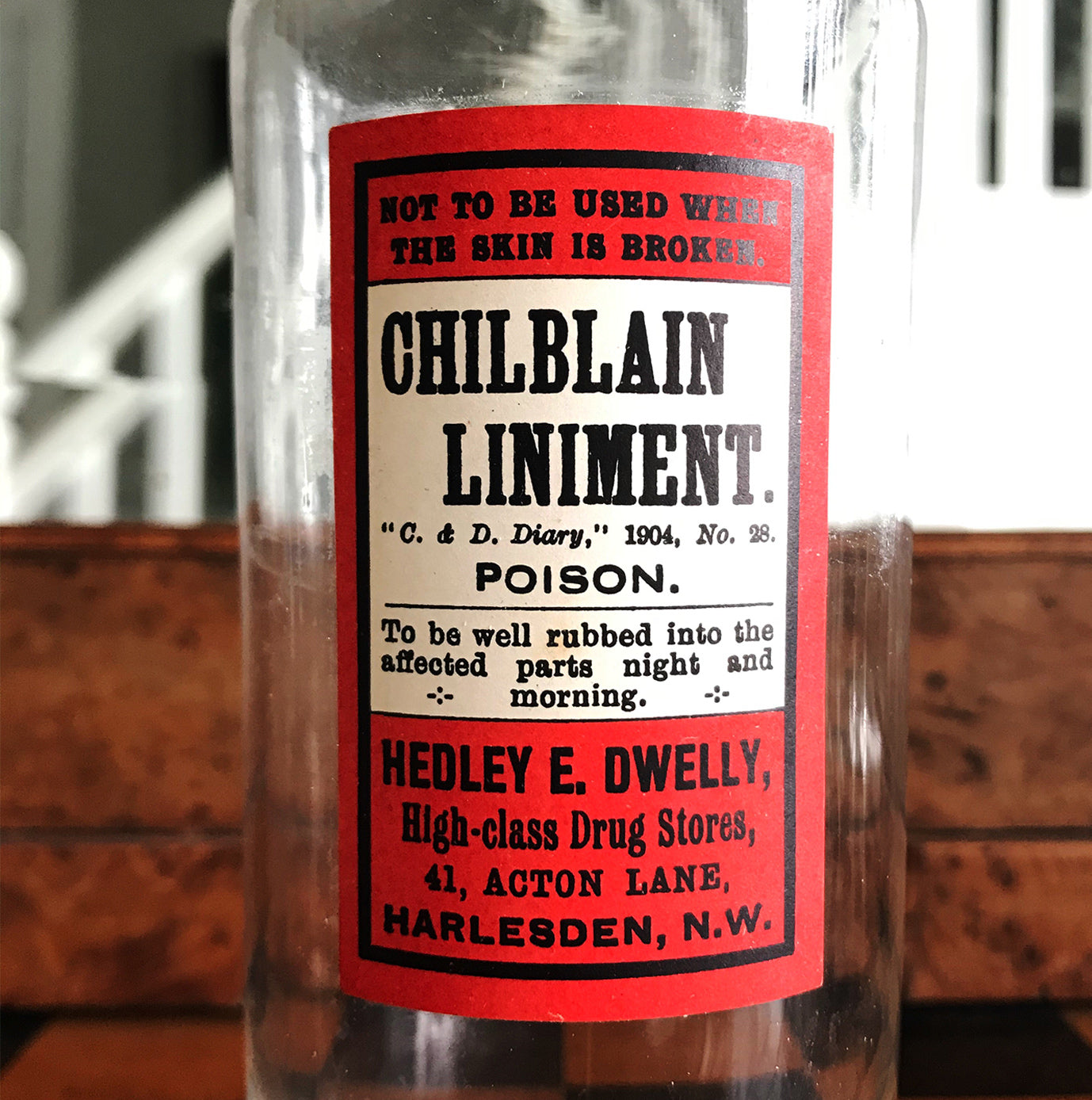 Vintage Apothecary Bottle with an original paper Poison label for Chilblain Liniment, Poison from Hedley E. Dwelly, High-Class Drug Stores, 41, Acton Lane, Harlesden. N.W. London - SHOP NOW - www.intovintage.co.uk