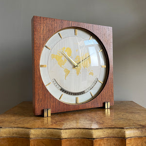 An impressive mid 20th Century World Timer mantel or table clock by Kienzle, Germany with the very rare teak wood surround. The face depicts the countries of the world showing the different time zones - SHOP NOW - www.intovintage.co.uk