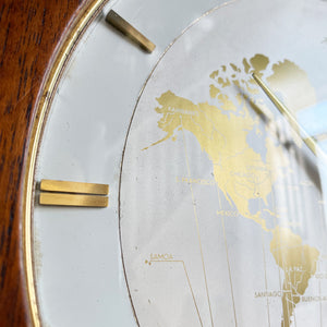 An impressive mid 20th Century World Timer mantel or table clock by Kienzle, Germany with the very rare teak wood surround. The face depicts the countries of the world showing the different time zones - SHOP NOW - www.intovintage.co.uk