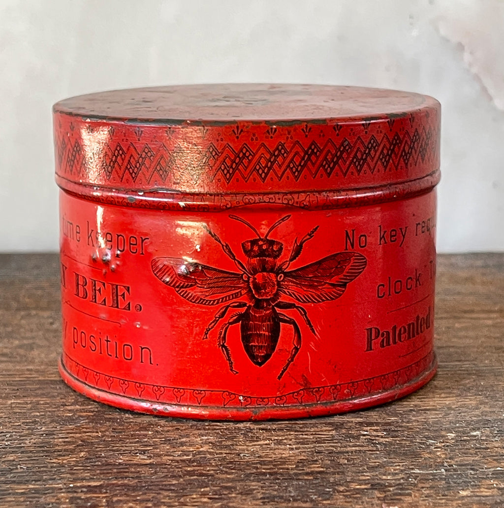 A sort after Vintage Anosonia Clock Tin by the Anisonia Clock Company of Brooklyn, New York. The tin was used to house the 'BEE' clock which required no key, all you had to do was twist its back - SHOP NOW - www.intovintage.co.uk